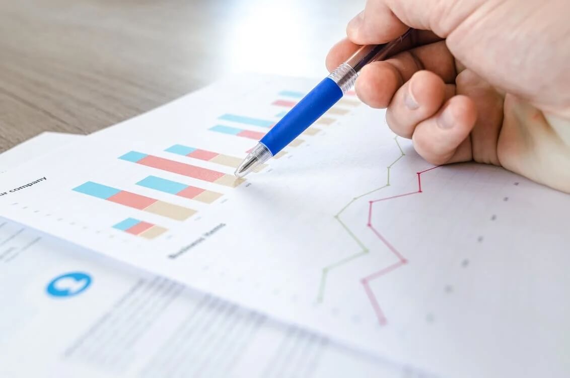 close-up photo of person reviewing printed spreadsheet