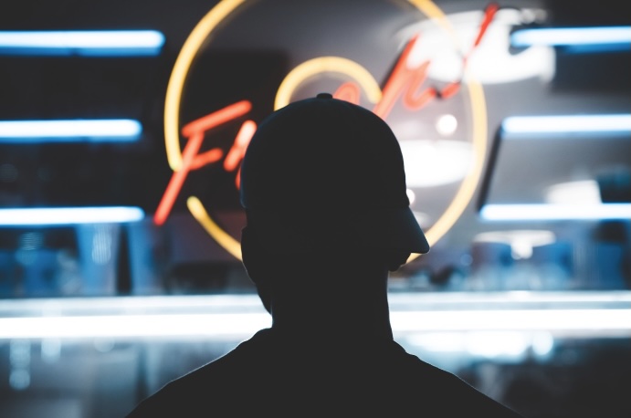 dark silhouette in front of digital sign