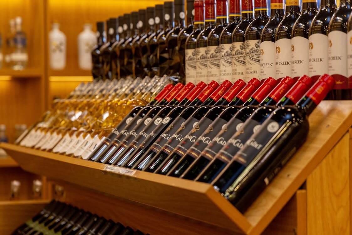 series of wine bottles displayed correctly on shelf