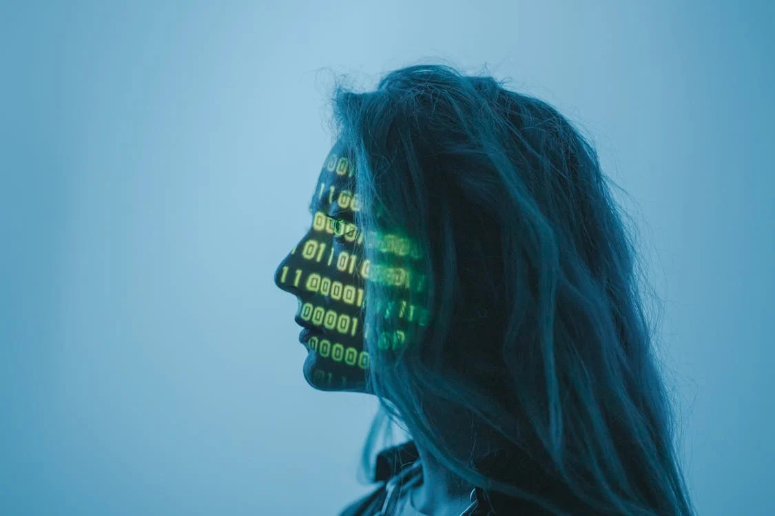 AI-vs-humans-concept-image-woman-with-binary-code-projected-on-face