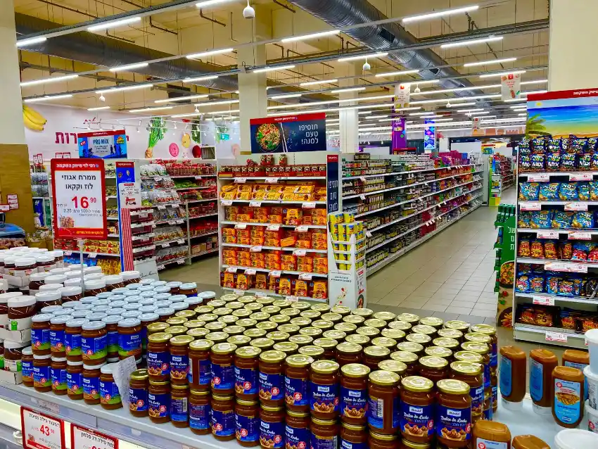 A fully stocked convenience store with shelves clearly lined up